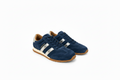 A pair of navy blue suede sneakers with metallic silver side stripes, a tan interior lining, and a brown gum sole, shown on a white background.