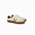 A pair of low-top sneakers in off-white leather and suede with a dusty pink V logo, brown gum soles, and black heel tabs, shown on a white background.